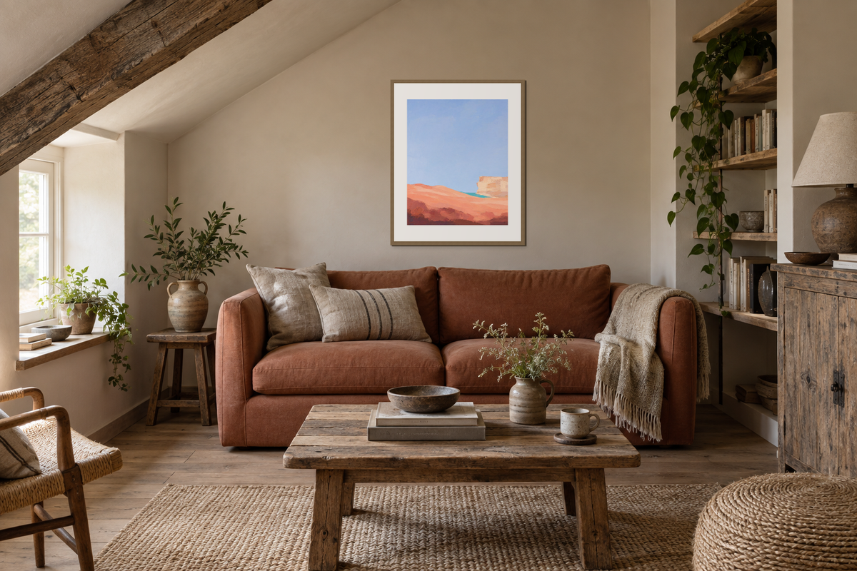 A framed abstract print on the usable wall below a sloping ceiling in a compact sitting room.