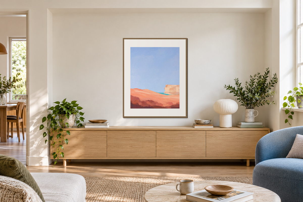 A complete portrait abstract print centered on a broad alcove wall above a low cabinet.