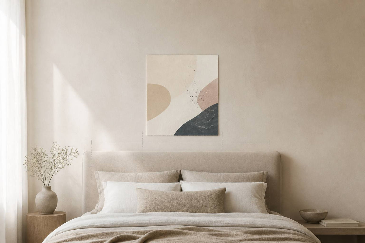Diagram showing art above a bed sized between one-half and three-quarters of the headboard width