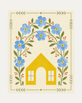 Bloom Cottage unframed cottage wall art print showing a yellow house under blue flowers