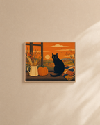 Black Cat Autumn Window unframed print is shown framed for styling in a plain wall; frame not included