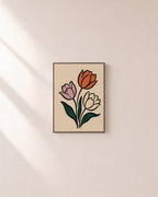 Three Tulips On Cream unframed print is shown framed for styling in a plain wall; frame not included