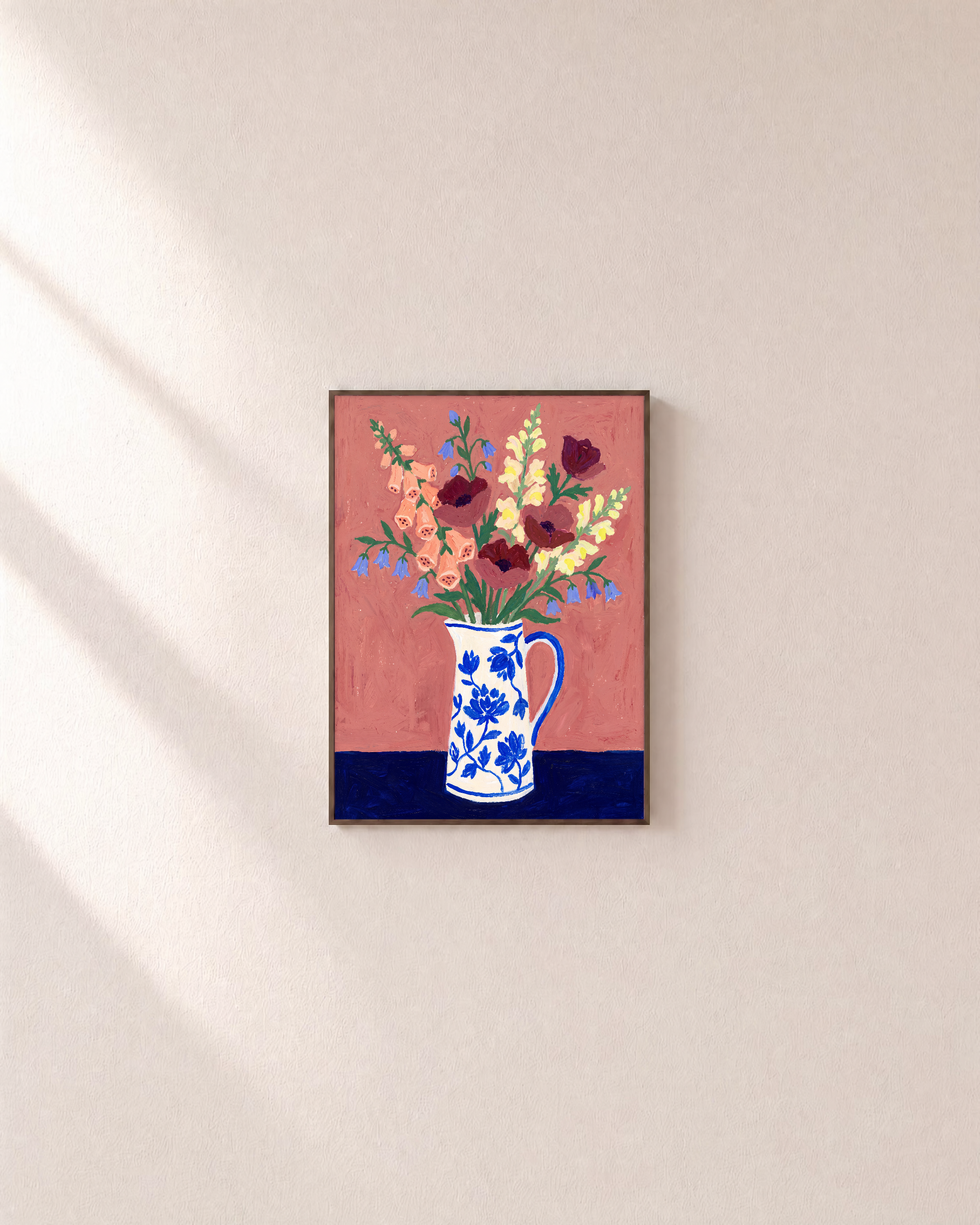 Terracotta floral print in a slim walnut frame on a plain wall