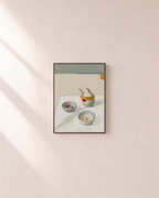 After Tea olive oil wall art: unframed print is shown framed for styling on a plain wall; frame not included