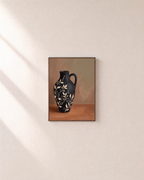 Black Amphora Motif unframed print is shown framed for styling in a plain wall; frame not included