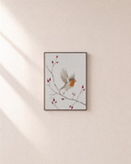 Passing Robin rosehip robin print: unframed print is shown framed for styling on a plain wall; frame not included
