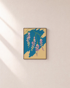 Sweet Peas Across Teal Slab unframed print is shown framed for styling in a plain wall; frame not included