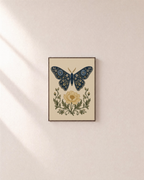Butter Bloom navy moth wall art: unframed print is shown framed for styling on a plain wall; frame not included