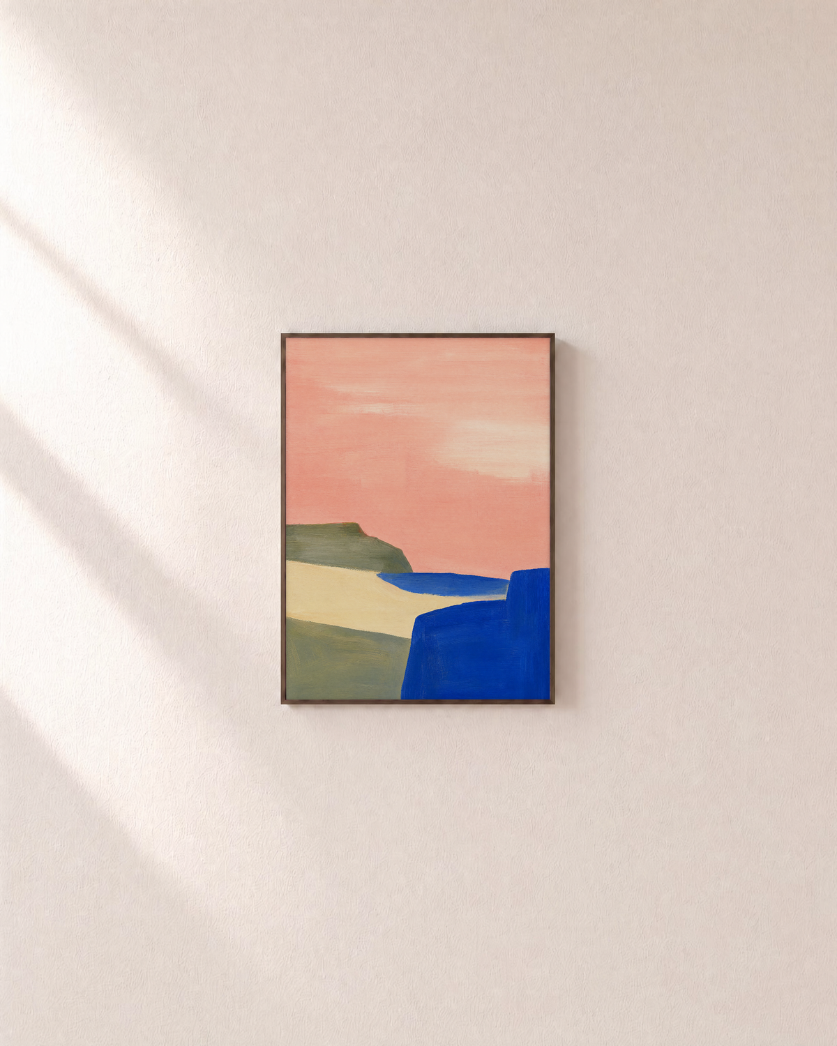 Pink Field Above Blue Cliff pink & blue abstract landscape wall art print: unframed print is shown framed for styling on a plain wall; frame not included