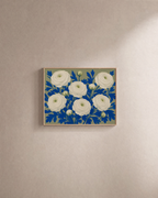 Ranunculus Thicket white ranunculus wall art: unframed print is shown framed for styling on a plain wall; frame not included