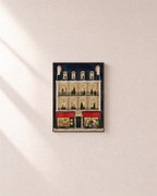 Christmas Bakery bakery house print: unframed print is shown framed for styling on a plain wall; frame not included