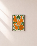 Vine Gourds orange gourd wall art: unframed print is shown framed for styling on a plain wall; frame not included