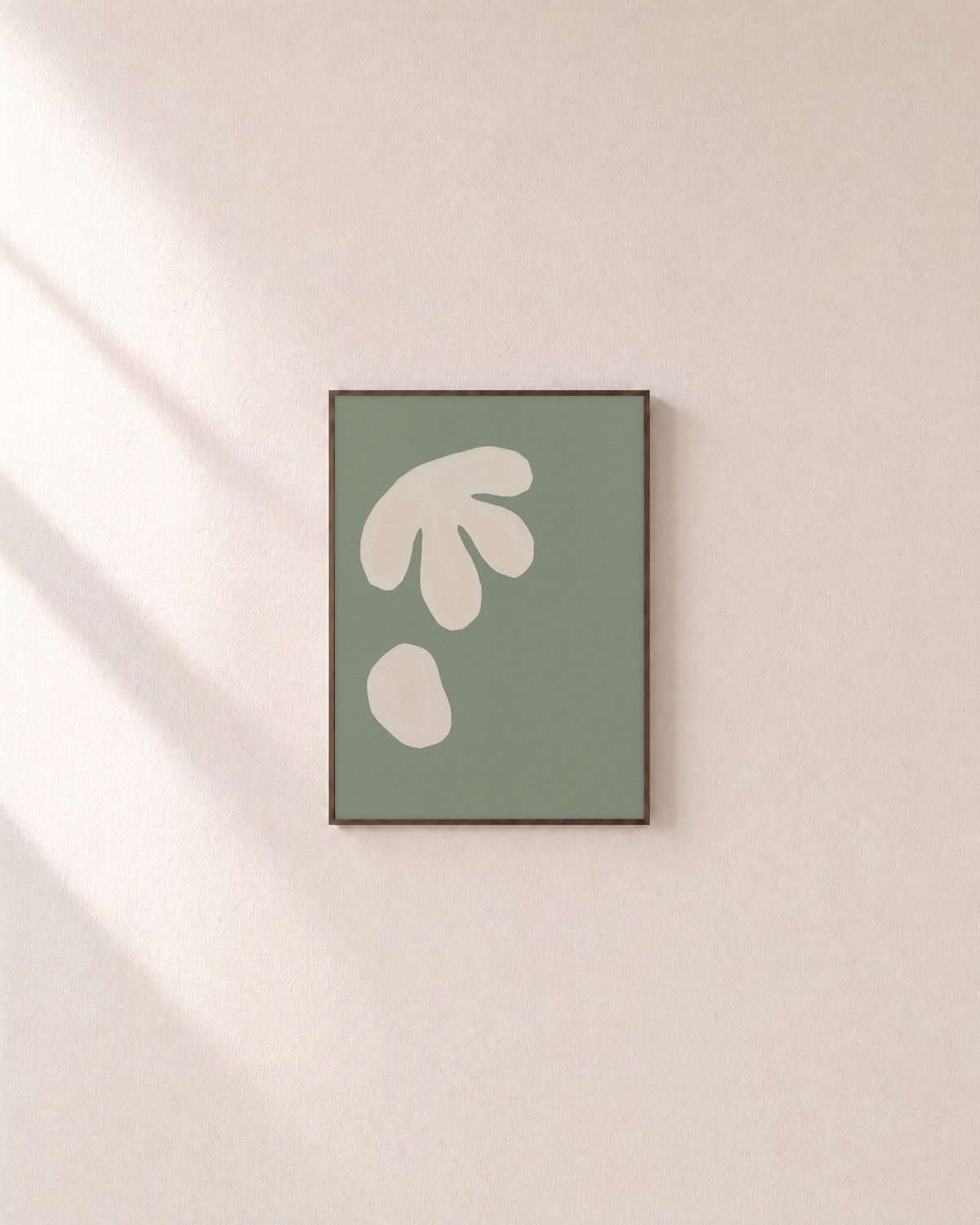Two Ivory Cutouts on Sage sage green abstract wall art print: unframed print is shown framed for styling on a plain wall; frame not included