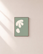 Cream Cutouts Sage unframed print is shown framed for styling in a plain wall; frame not included