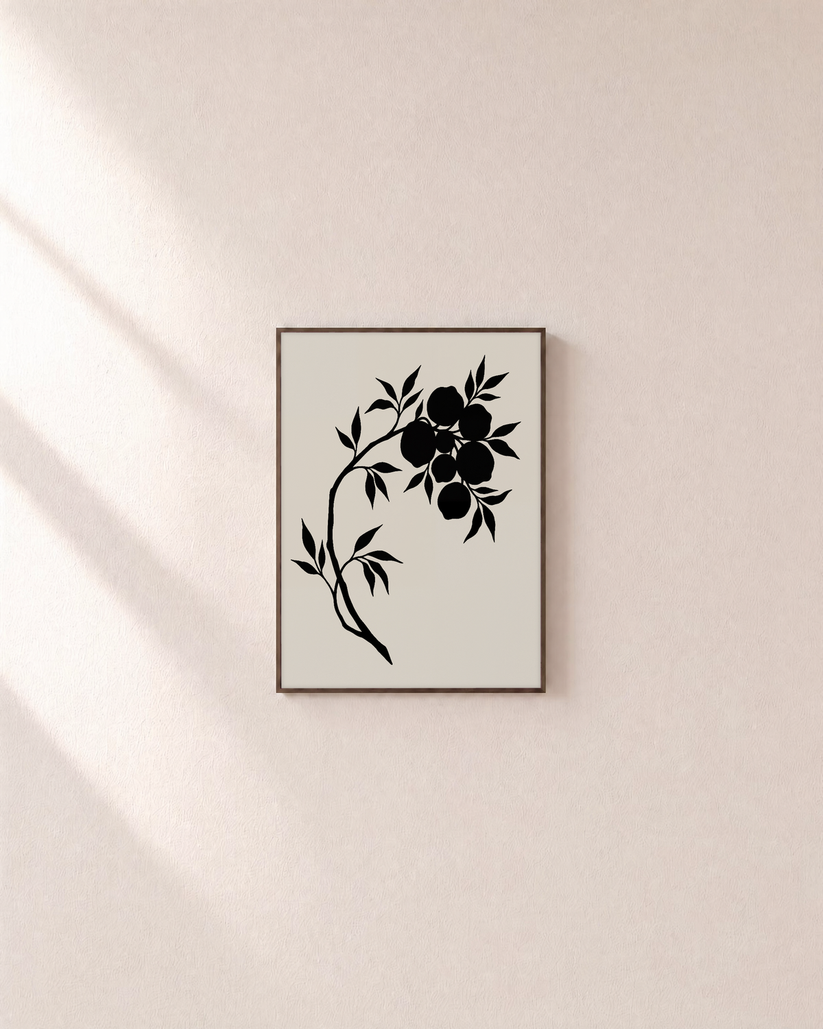 Black Leaves and Fruit black botanical silhouette wall art print: unframed print is shown framed for styling on a plain wall; frame not included