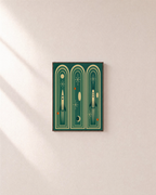 Three Launches teal rocket arch print: unframed print is shown framed for styling on a plain wall; frame not included