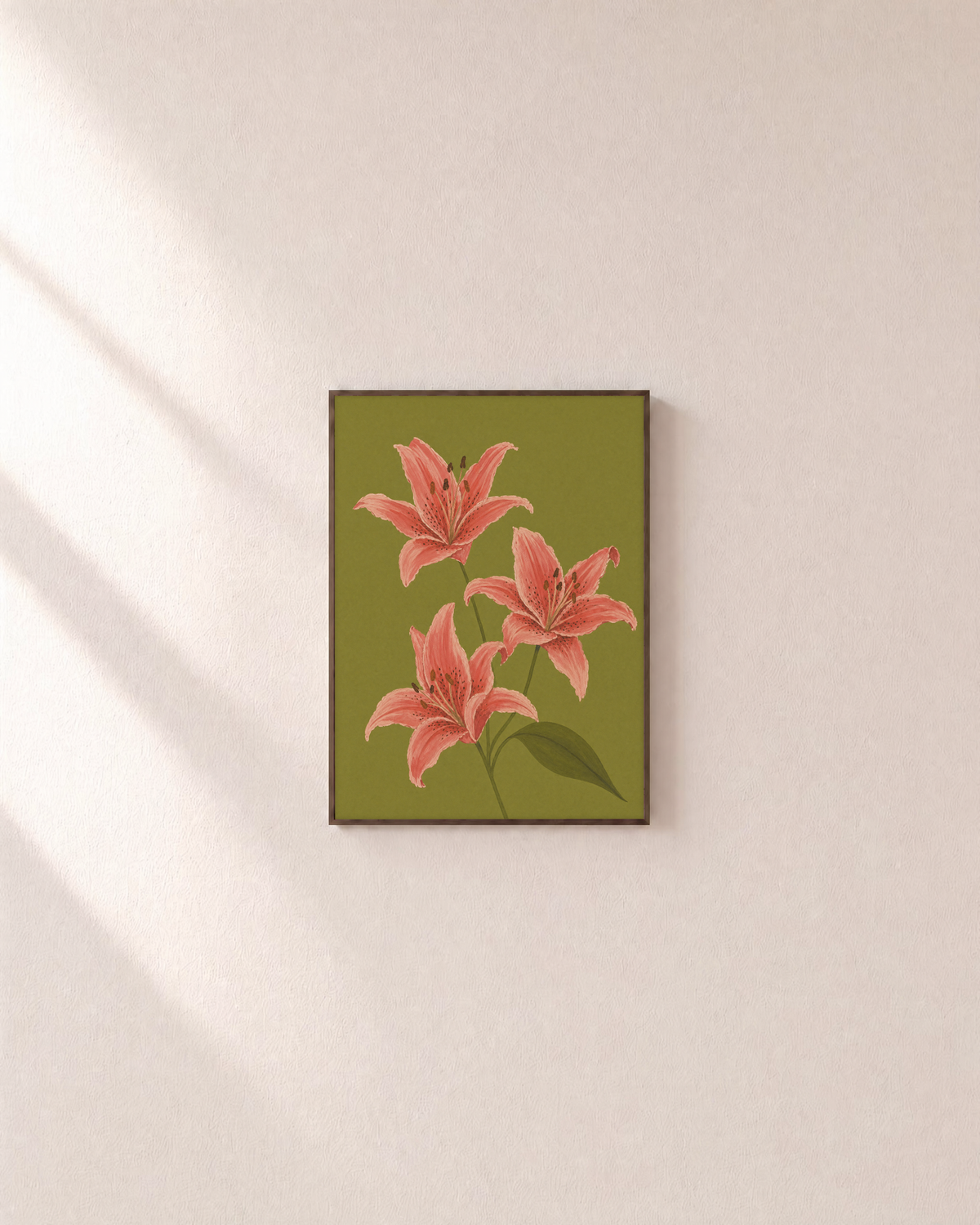 Three Coral Spotted Lilies One Olive Leaf Blade unframed print is shown framed for styling in a plain wall; frame not included