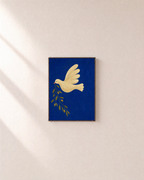 Dove Branch Blue unframed print is shown framed for styling in a plain wall; frame not included