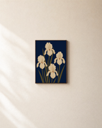 Cream Irises On Navy Field unframed print is shown framed for styling in a plain wall; frame not included
