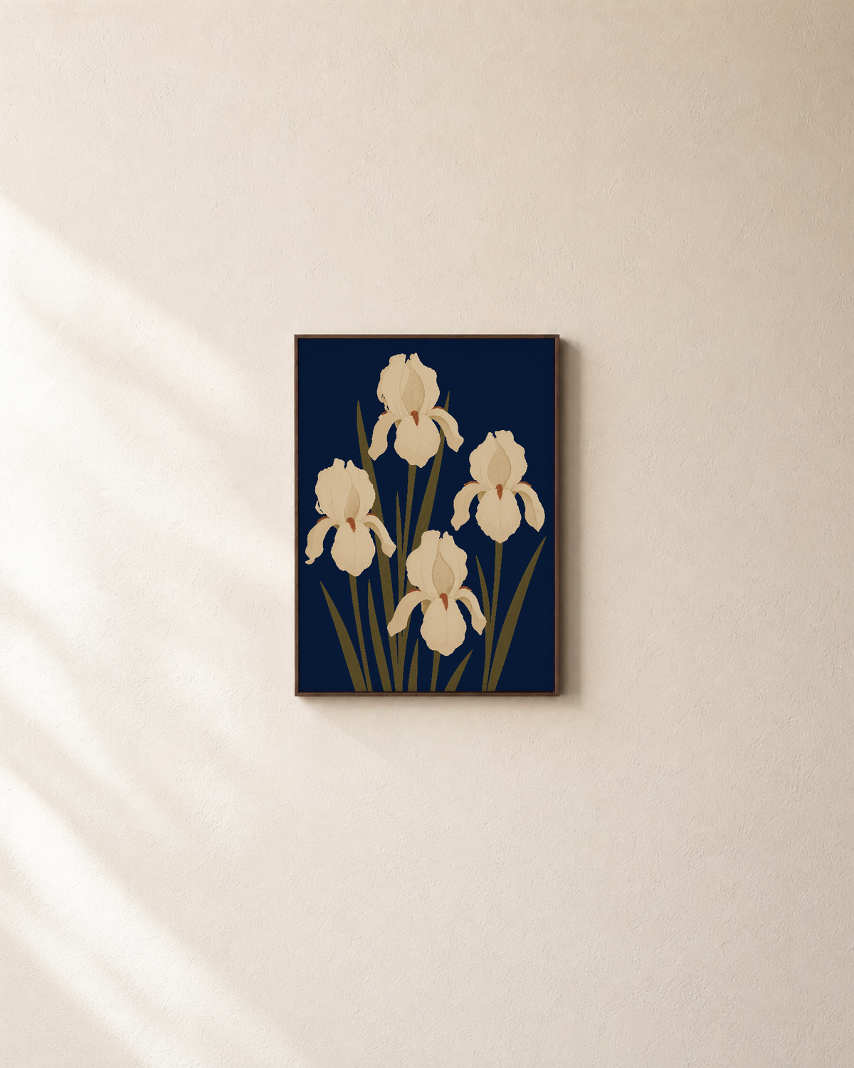 Cream Irises On Navy Field unframed print is shown framed for styling in a plain wall; frame not included