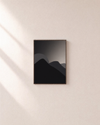Black Peaks with Pale Sun minimalist mountain silhouette wall art print: unframed print is shown framed for styling on a plain wall; frame not included