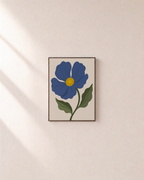 Blue Bloom blue flower art prints: unframed print is shown framed for styling on a plain wall; frame not included