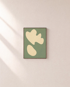 Cream Cutouts Sage unframed print is shown framed for styling in a plain wall; frame not included