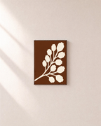 Cream Bloom Brown unframed print is shown framed for styling in a plain wall; frame not included