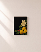 Lemon Magnolia Dark unframed print is shown framed for styling in a plain wall; frame not included
