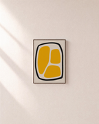 Looped Blocks yellow block loop wall art: unframed print is shown framed for styling on a plain wall; frame not included