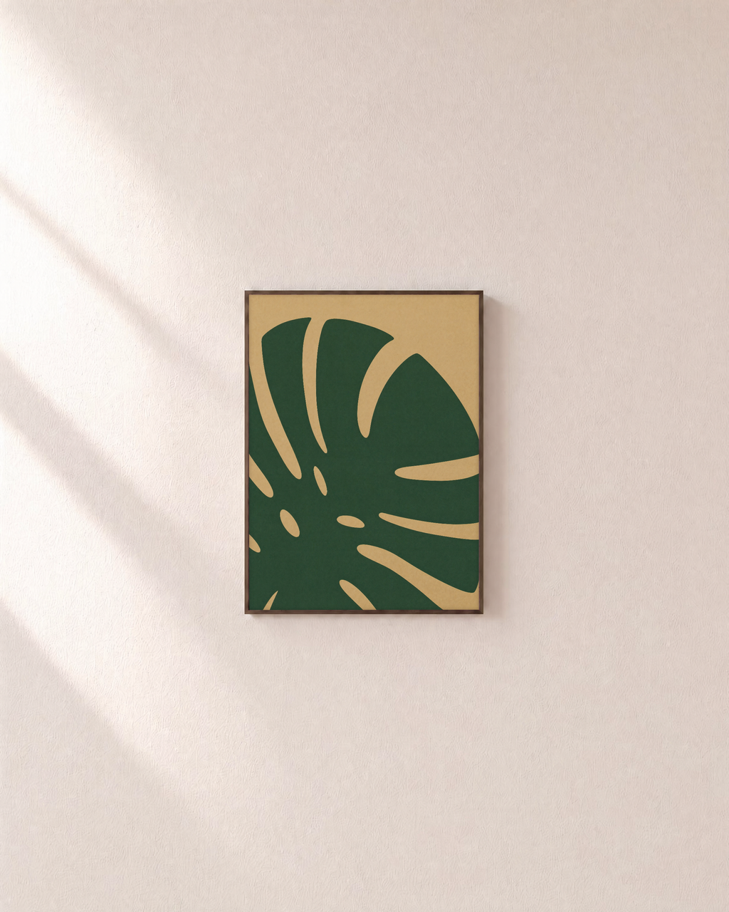Monstera Cut monstera leaf wall art: unframed print is shown framed for styling on a plain wall; frame not included