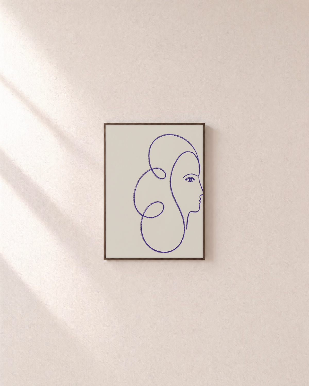 The Glance blue line art face print: unframed print is shown framed for styling on a plain wall; frame not included