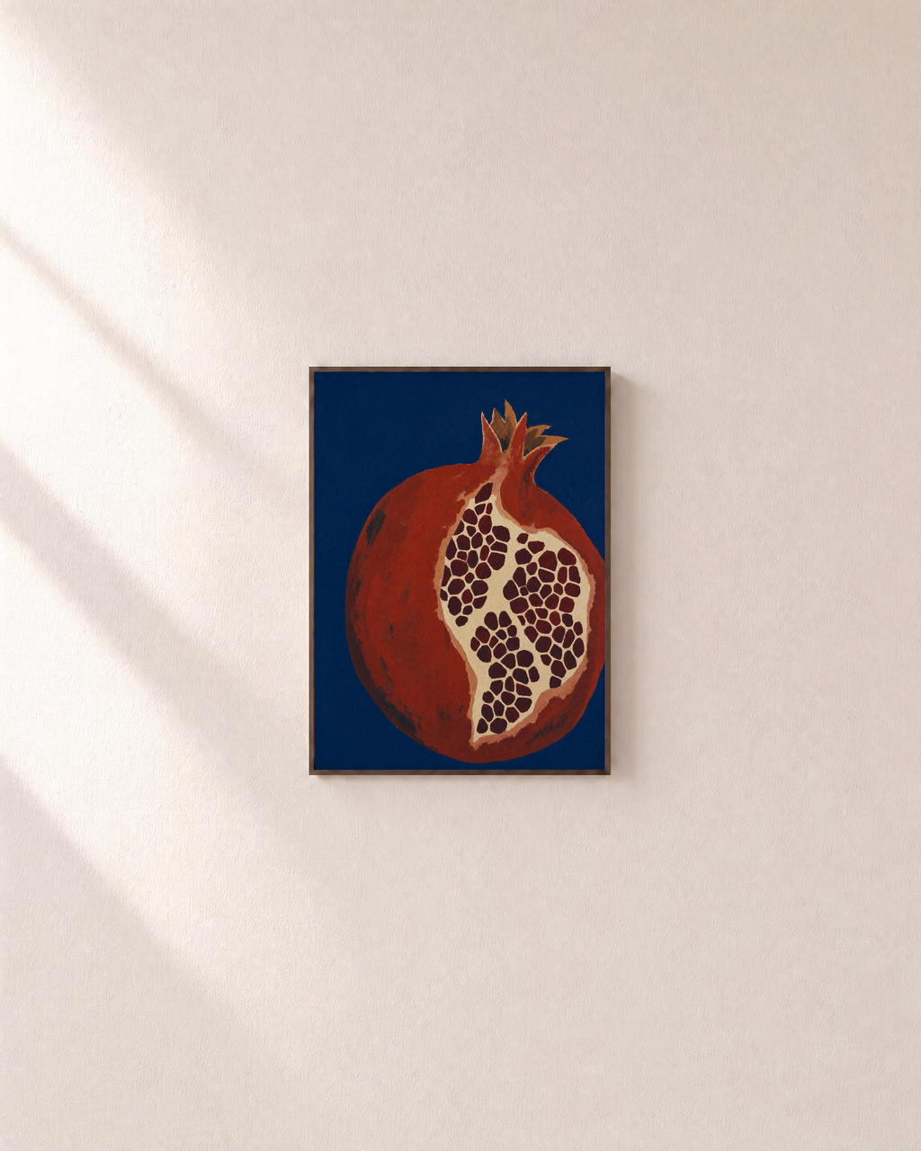 Night Pomegranate split pomegranate wall art: unframed print is shown framed for styling on a plain wall; frame not included