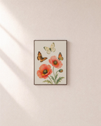 Poppy Visitors poppy butterfly print: unframed print is shown framed for styling on a plain wall; frame not included