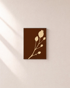 Cream Bloom Brown unframed print is shown framed for styling in a plain wall; frame not included