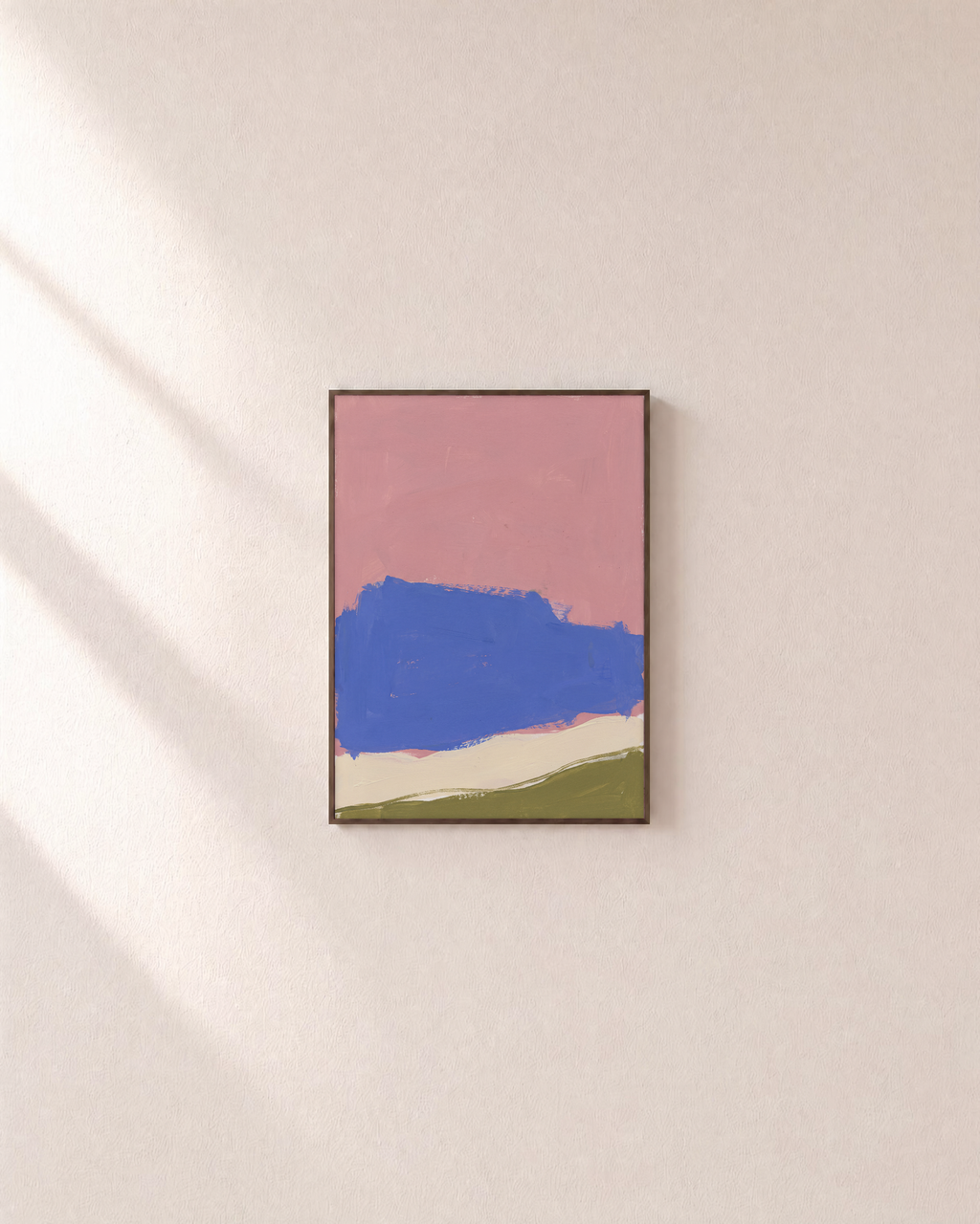 Blue Landform Over Pink Bands blue and pink abstract wall art: unframed print is shown framed for styling on a plain wall; frame not included