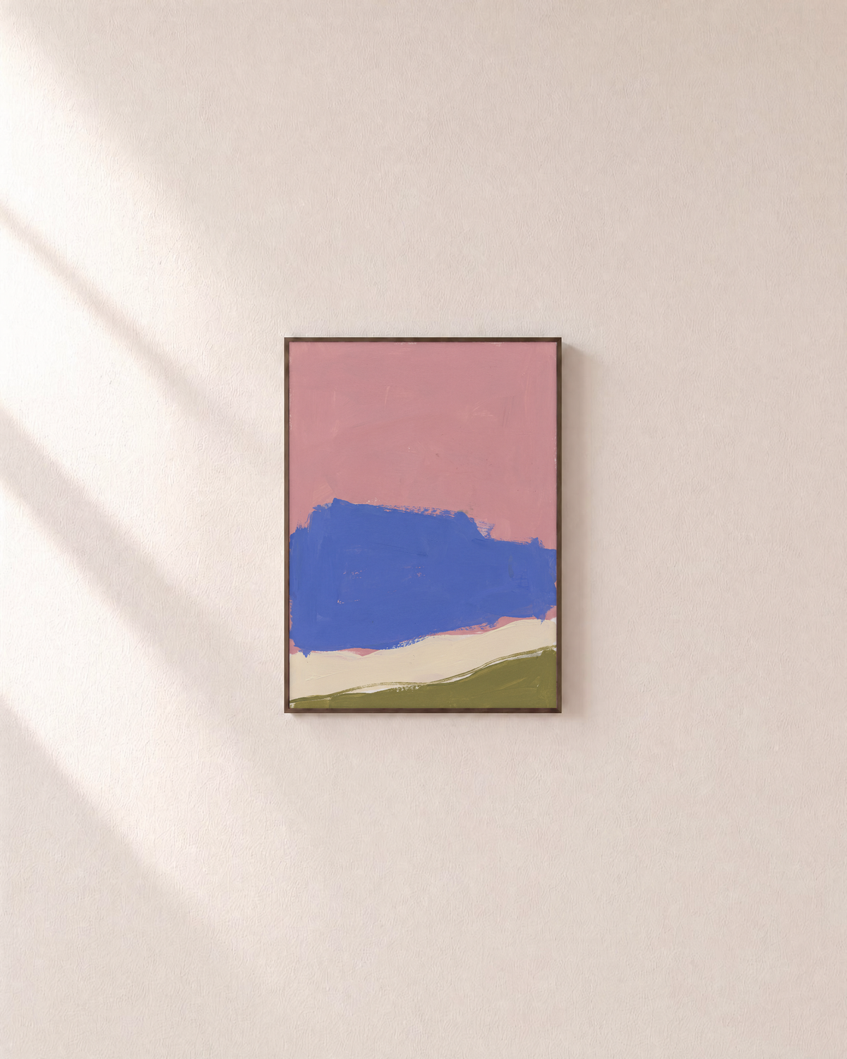 Blue Landform Over Pink Bands blue and pink abstract wall art: unframed print is shown framed for styling on a plain wall; frame not included