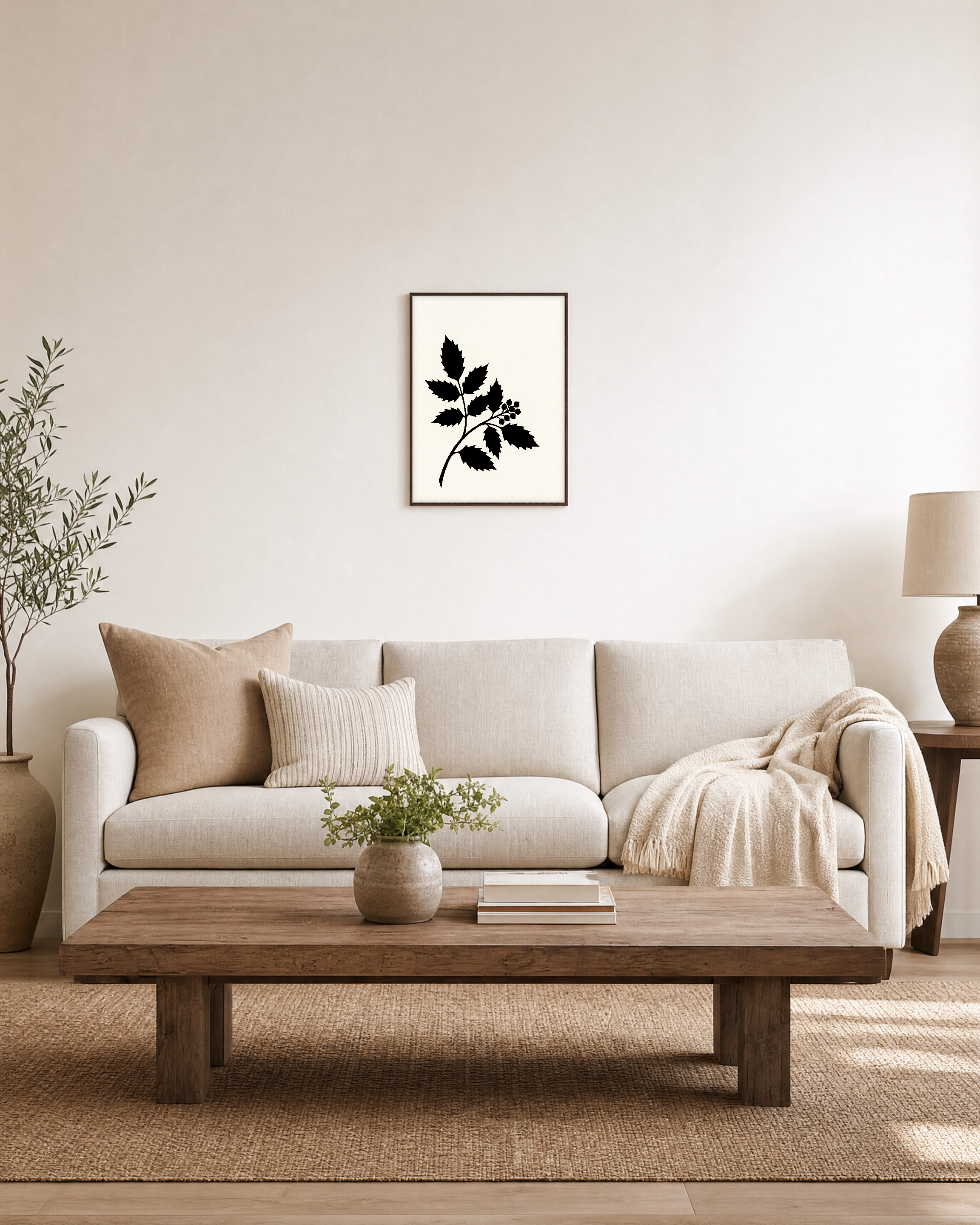 Black Leaf Sprig unframed print is shown framed for styling in a living room; frame not included