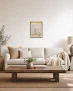 Morning Bottles citrus bottle still life wall art: unframed print is shown framed for styling in a living room; frame not included