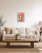 Morning Blooms coral botanical prints: unframed print is shown framed for styling in a living room; frame not included