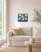Ranunculus Thicket white ranunculus wall art: unframed print is shown framed for styling in a living room; frame not included