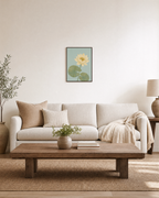 Lotus Pause single lotus wall art: unframed print is shown framed for styling in a living room; frame not included