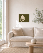 Ivory Seed Pod on Olive Field olive green floral wall art print: unframed print is shown framed for styling in a living room; frame not included