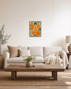 Vine Gourds orange gourd wall art: unframed print is shown framed for styling in a living room; frame not included