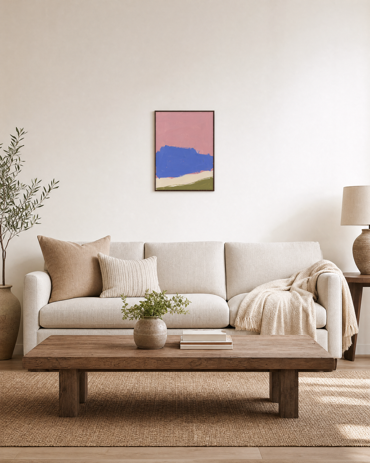 Blue Landform Over Pink Bands blue and pink abstract wall art: unframed print is shown framed for styling in a living room; frame not included