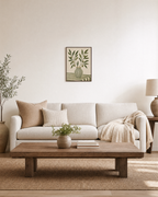 Olive Keeper olive branch print: unframed print is shown framed for styling in a living room; frame not included