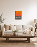 Low Sun orange sun ripple wall art: unframed print is shown framed for styling in a living room; frame not included