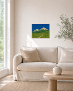 High Meadow mountain landscape wall art: unframed print is shown framed for styling in a living room; frame not included