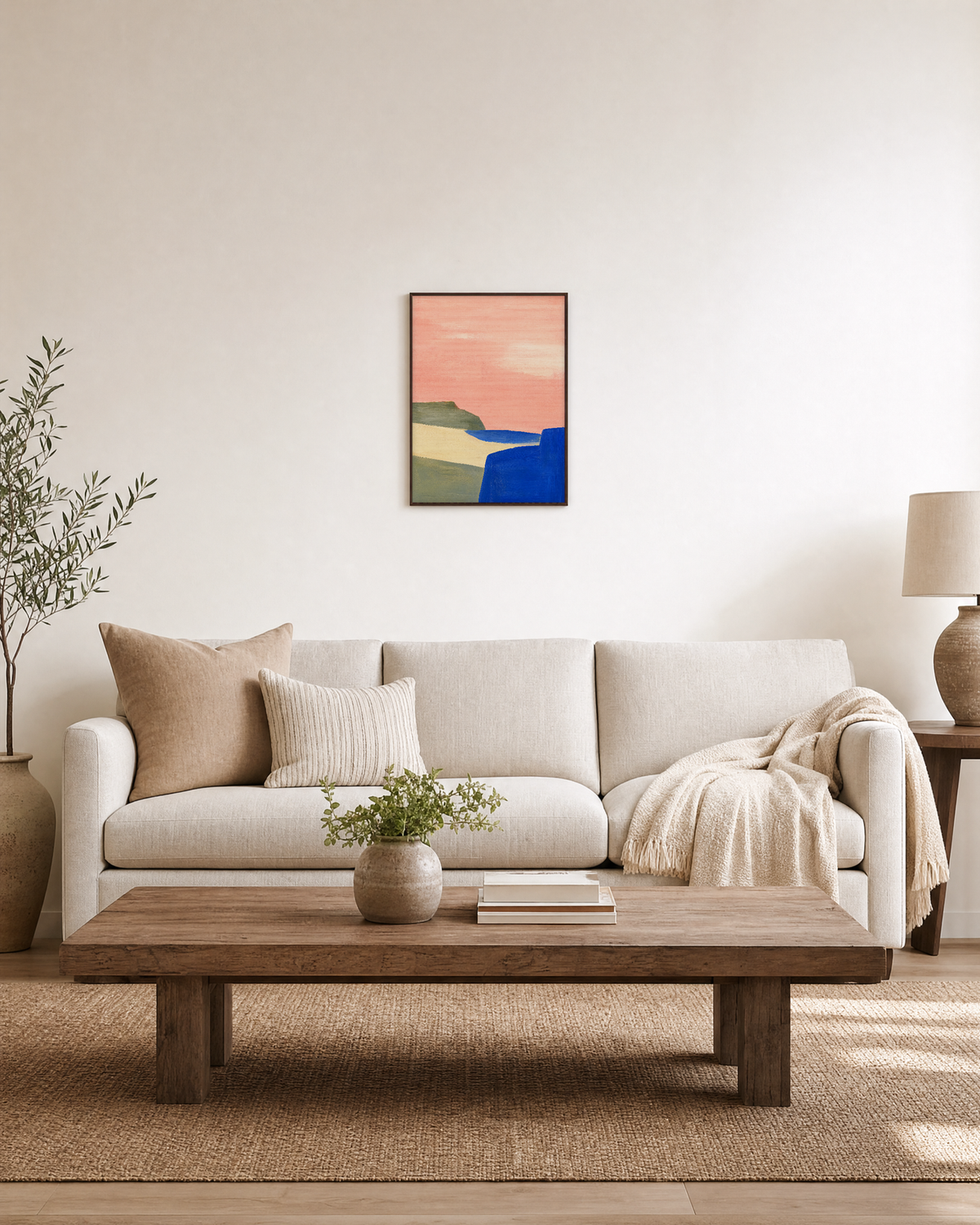 Pink Field Above Blue Cliff pink & blue abstract landscape wall art print: unframed print is shown framed for styling in a living room; frame not included