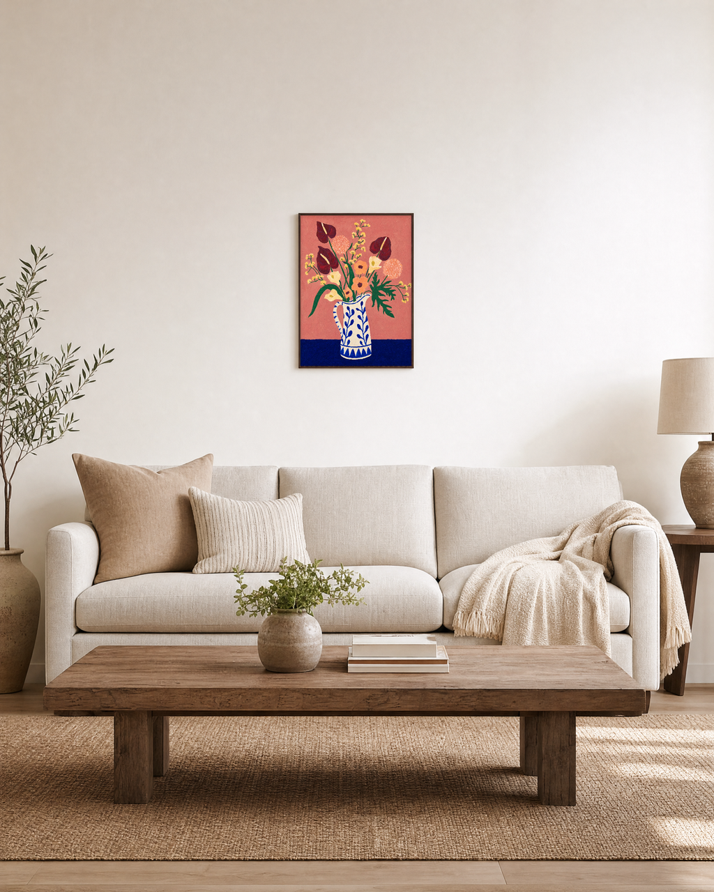 Blue pitcher floral wall art styled above a living room sofa